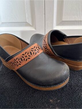 Dansko Black Leather Clogs with Brown Laser-Cut Accent